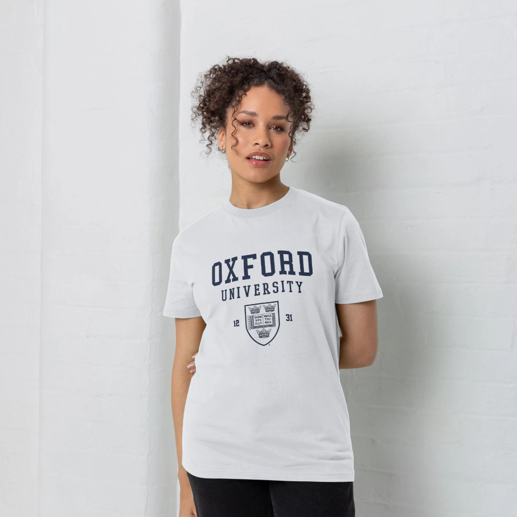 Person wearing a white t-shirt with 'Oxford University' text and logo on a plain background