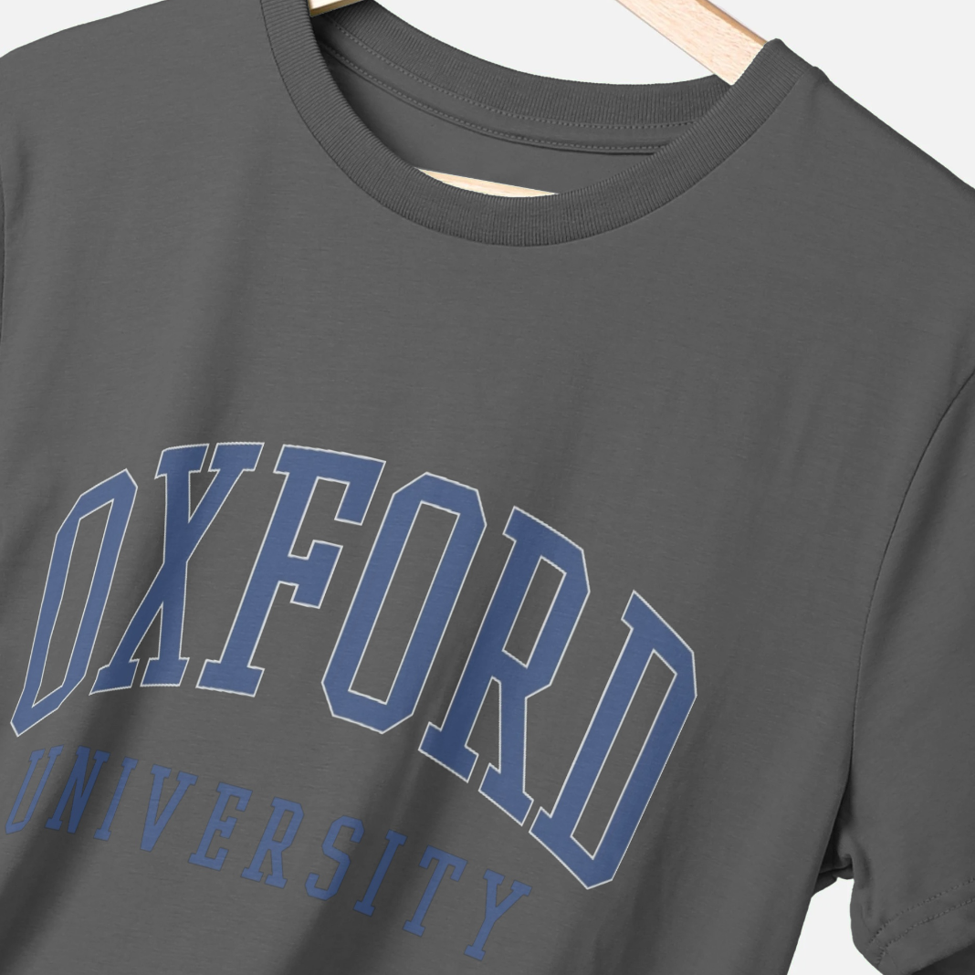 Gray t-shirt with 'OXFORD UNIVERSITY' printed in blue on a hanger.