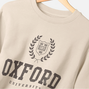 Beige sweatshirt with 'Oxford University' print on a hanger