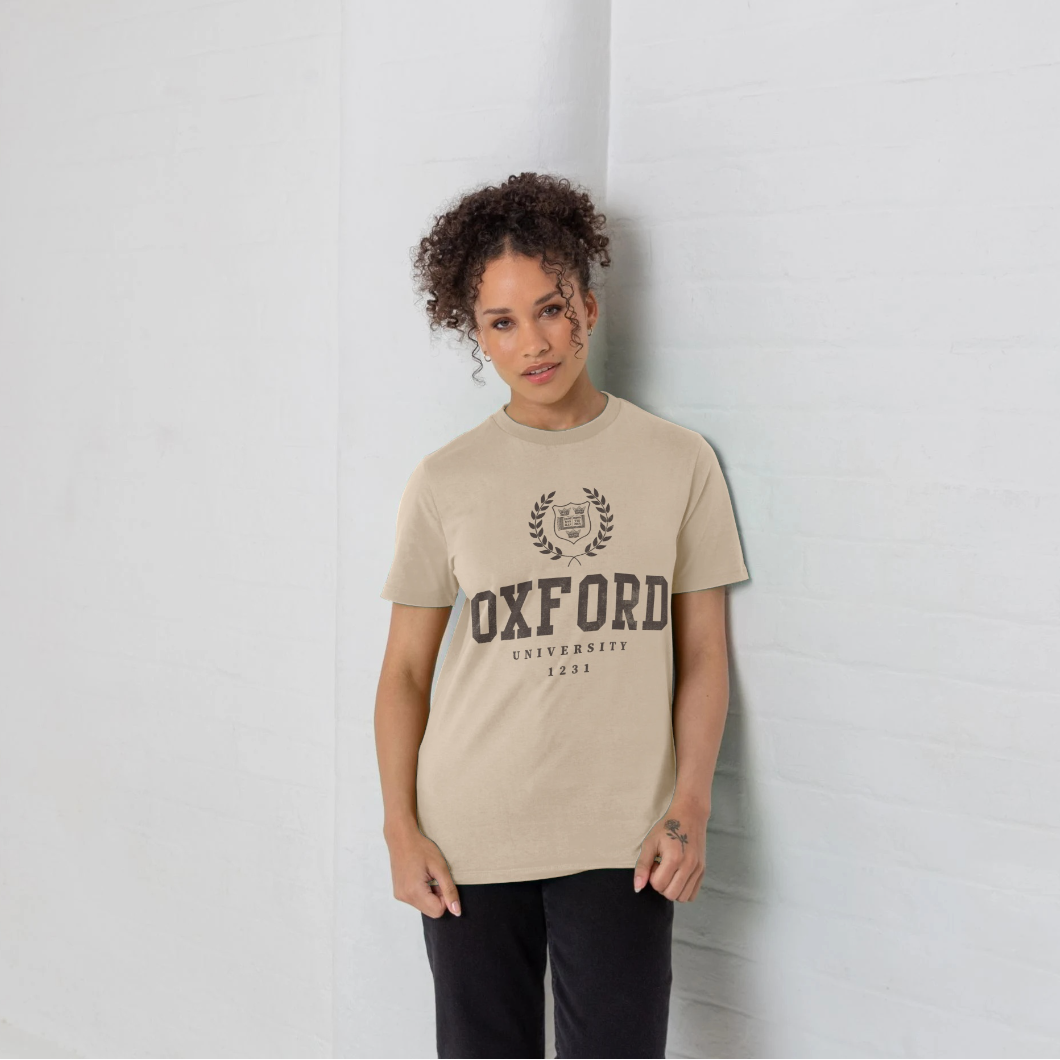 Person wearing a beige t-shirt with 'Oxford University' print against a light gray background